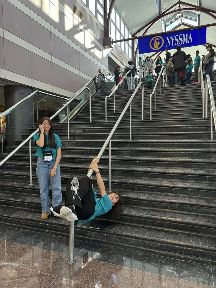 BHS students at NYSSMA festival, one is hanging by all fours from a railing