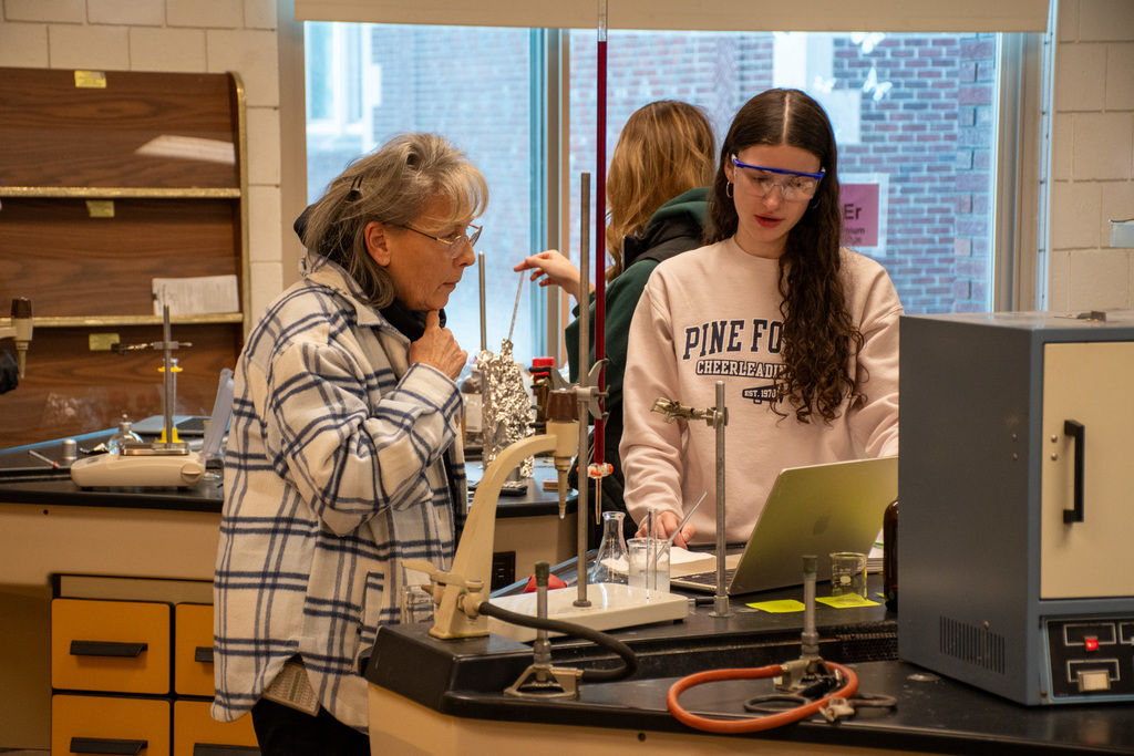 mrs. spalik-mucci assists chemistry student