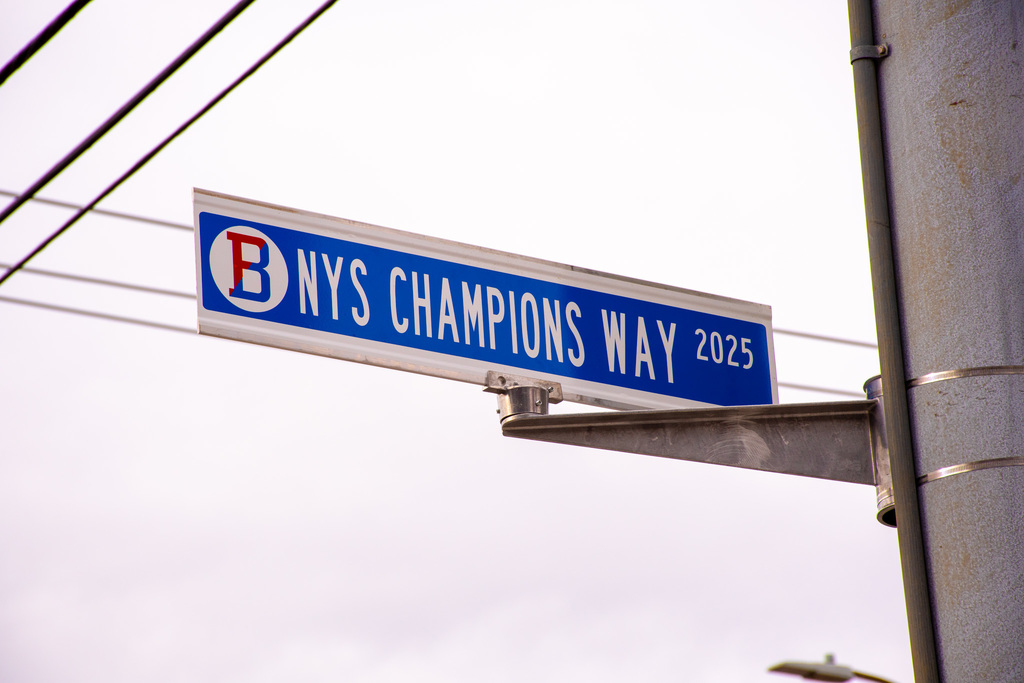 street sign reading nys champions way 2025