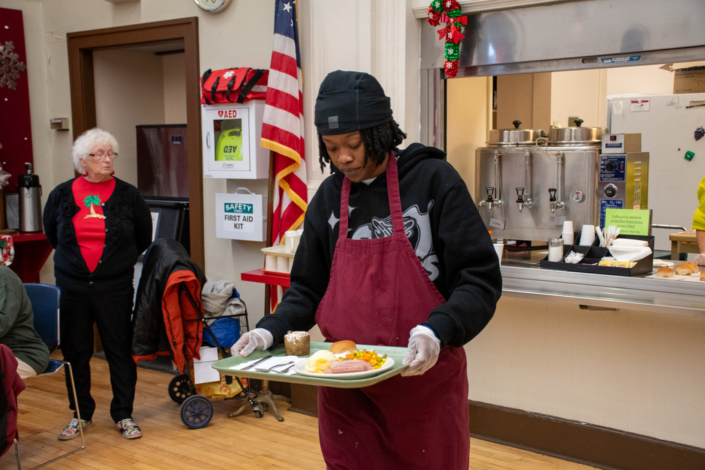 girls basketball player serves lunch