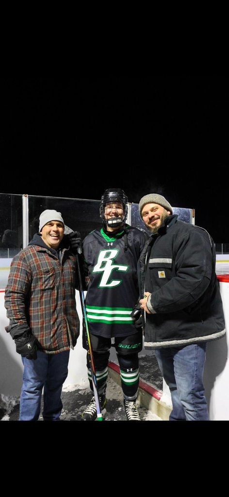 teachers pose for photo with hockey player