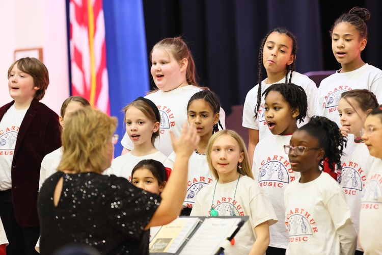 music teacher conducts chorus