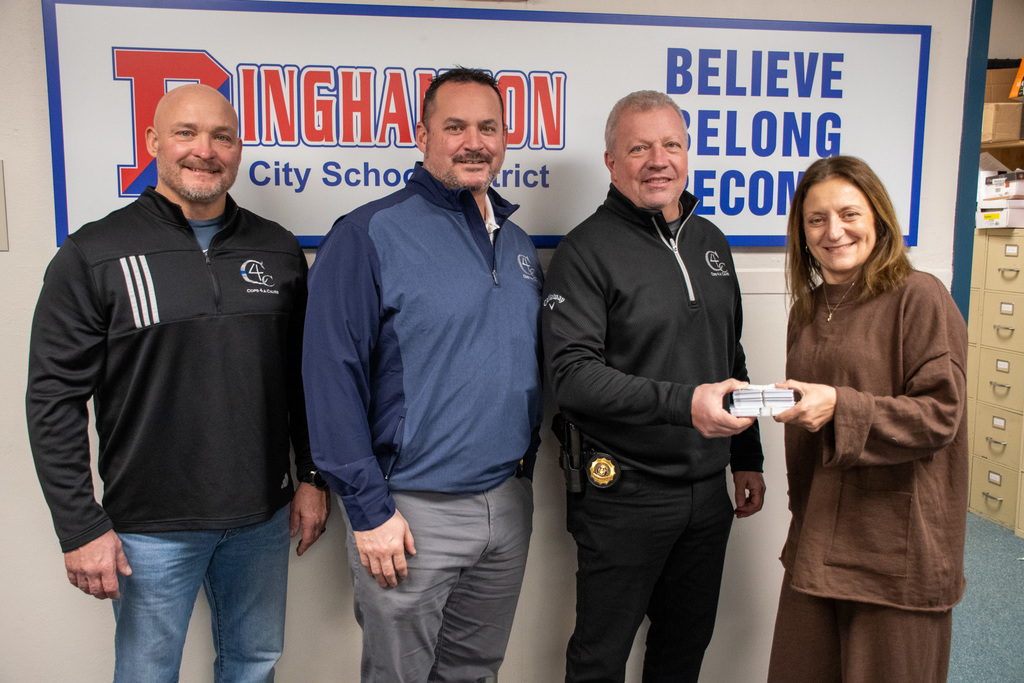 representatives from cops for a cause pose for a photo with binghamton superintendent
