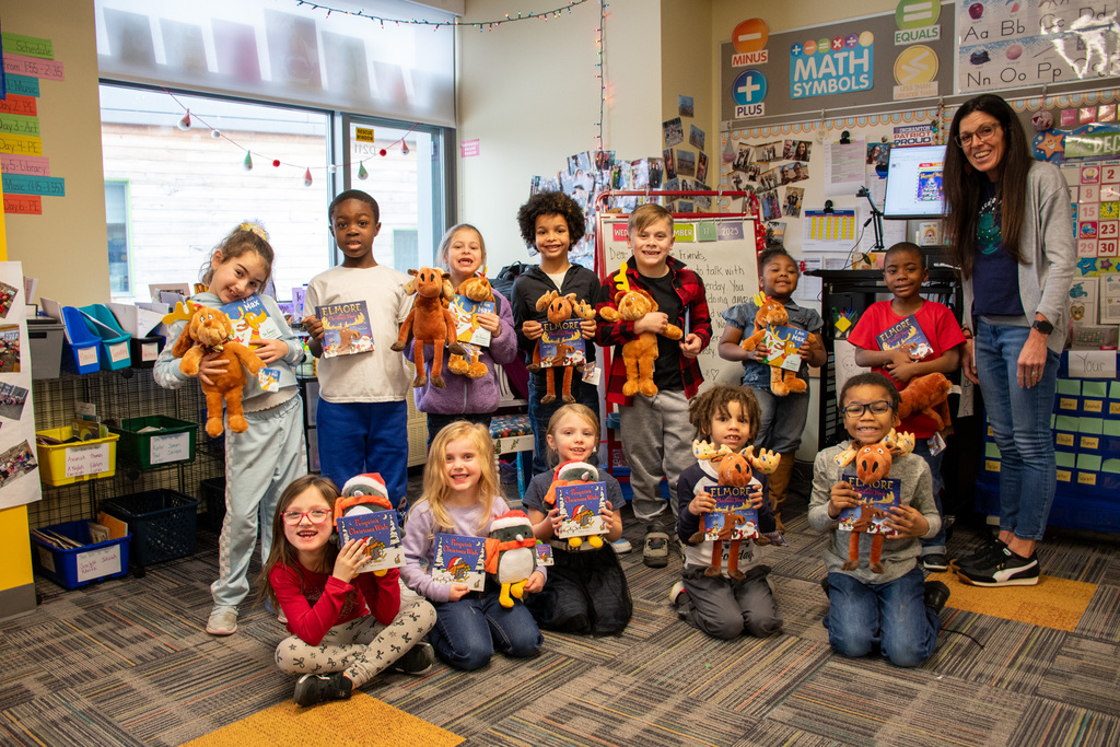 students in mrs. repp's first grade class at macarthur hold up gifts from their book fairy