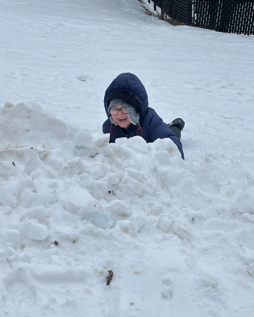 pre k student playing in snow