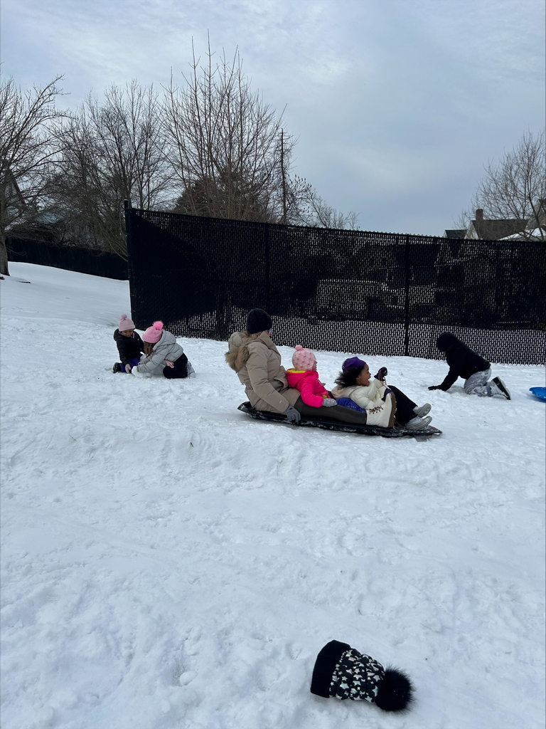 pre k students sledding with teacher