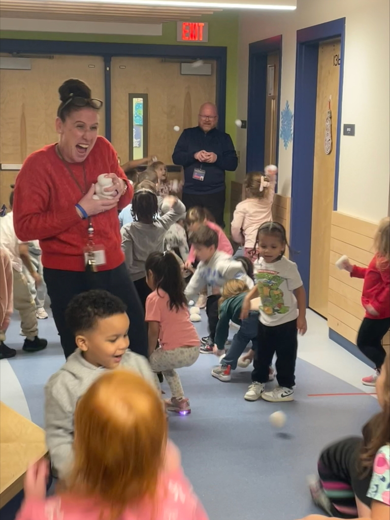 students and principals play with indoor snowballs