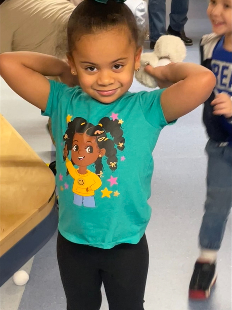 franklin student holds indoor stuffed snowballs