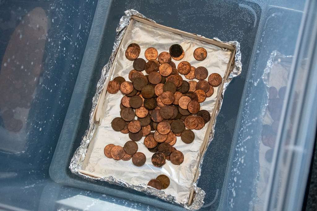 pennies sit on top of boat made by students in challenge enrichment