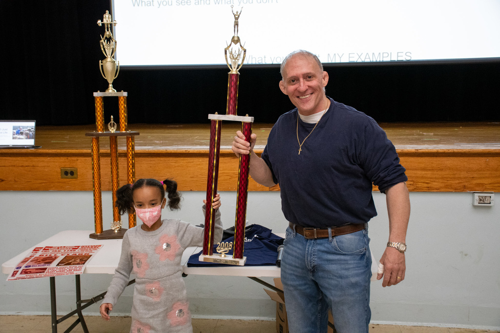 bill clark and student hold up trophy