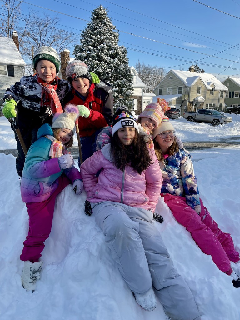 kids sitting on snow bank