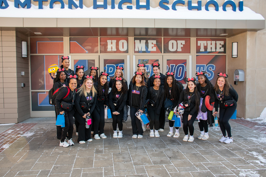 bhs cheer team poses for photo outside of school