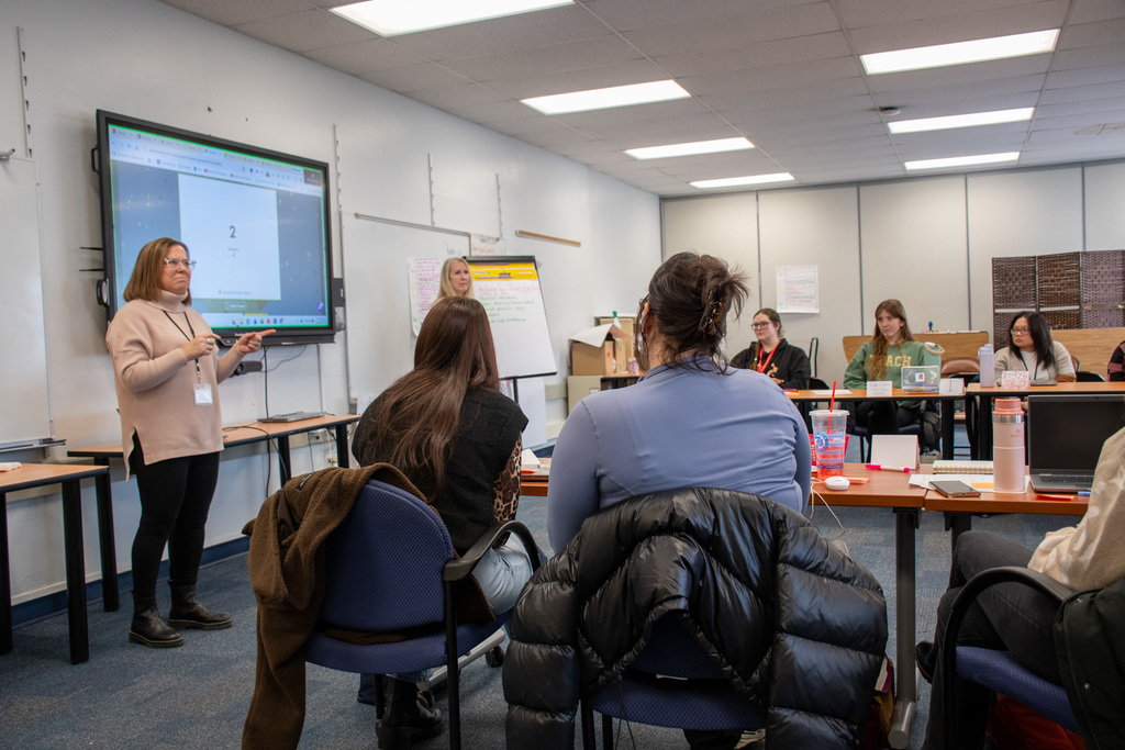 teachers listen to presentation given by retired teacher patti fiato