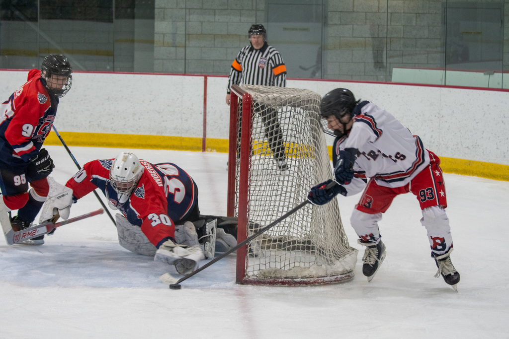 patriots hockey forward max lisio attempts a shot on goal