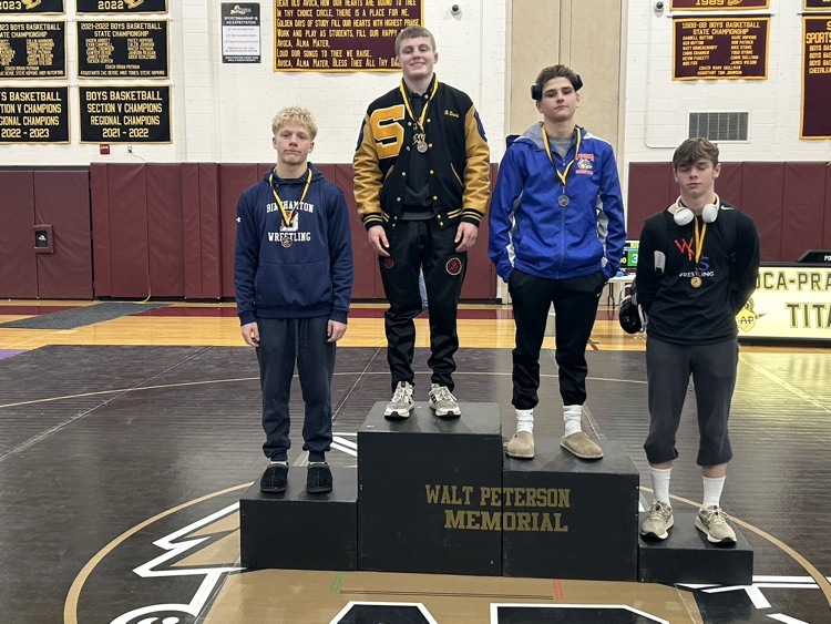 wrestlers standing on podium