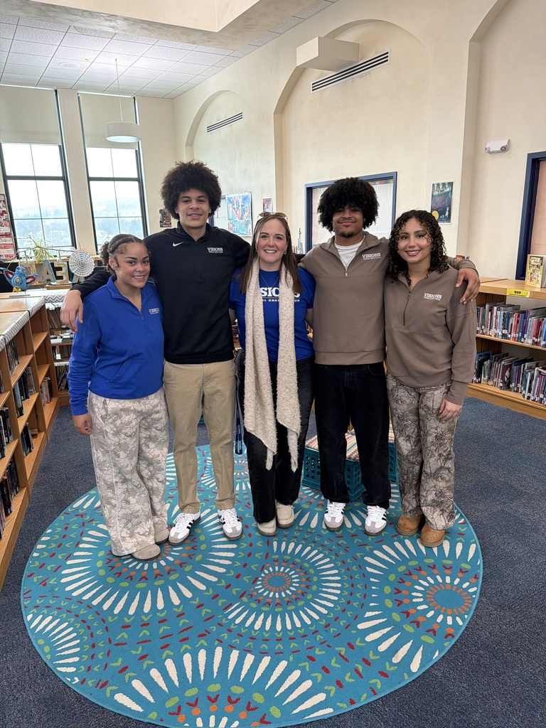 visions fcu interns pose for photo at west middle school library