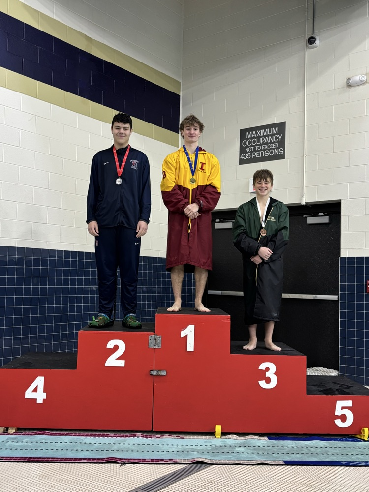 Joaquin Cosme standing on second place step of winners’ podium