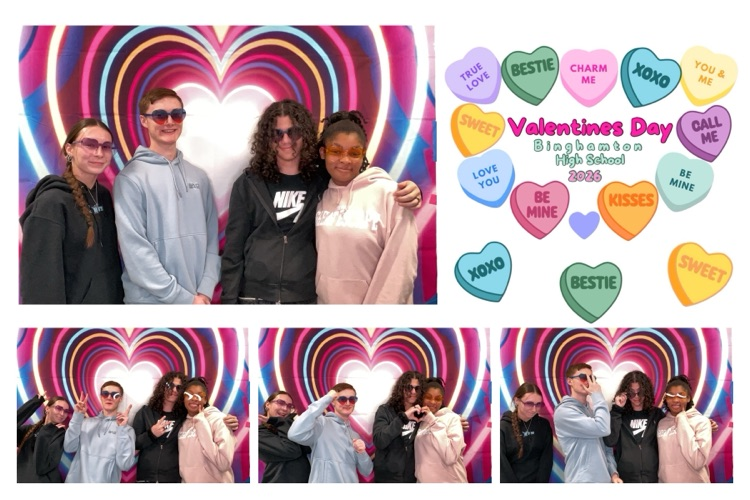 students posing in front of heart background in Photo Booth
