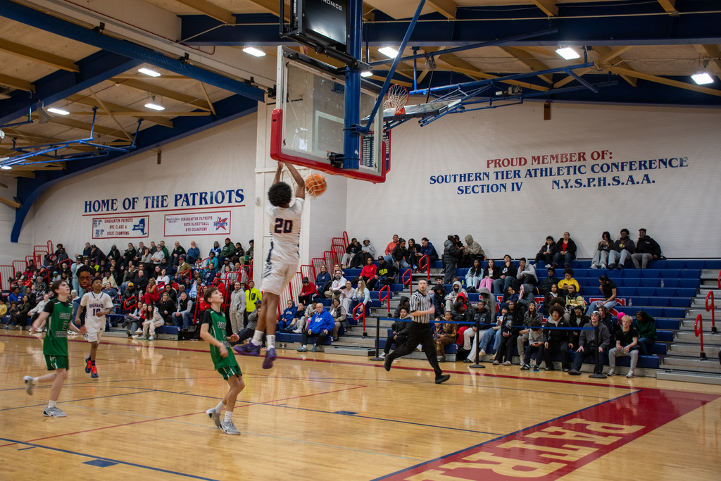 boys jv basketball player dunks during game against seton