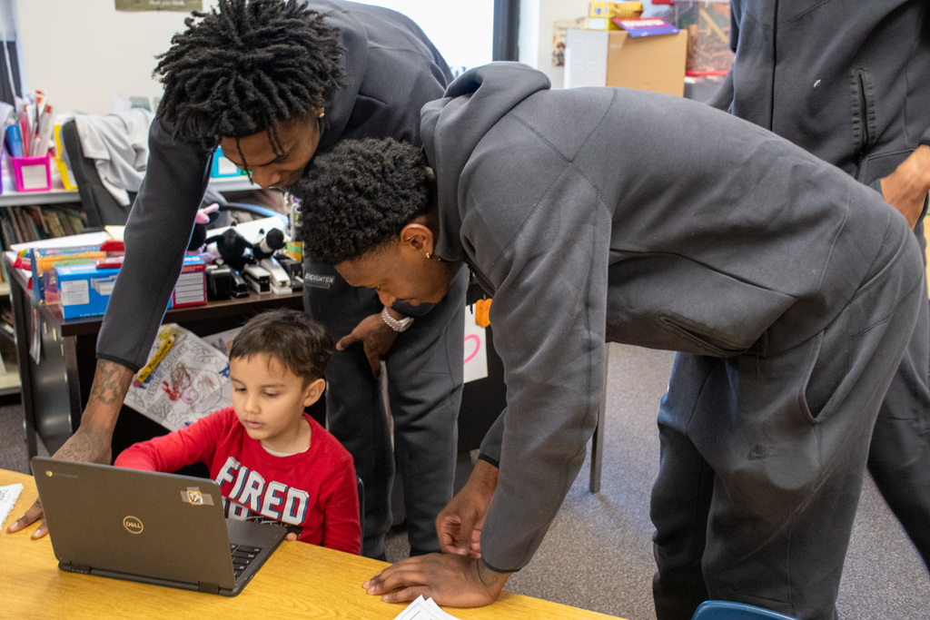 two binghamton university men's basketball players help kindergarten student 