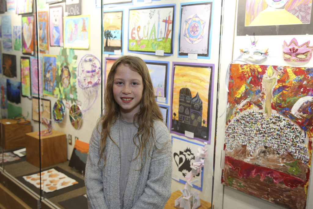 student poses for photo at the 2025 district art show