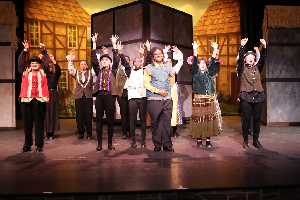 students on stage performing "something rotten!"