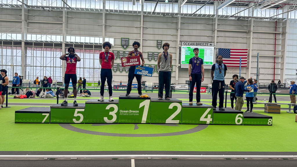 students stand on medal podium at the nys indoor track championships