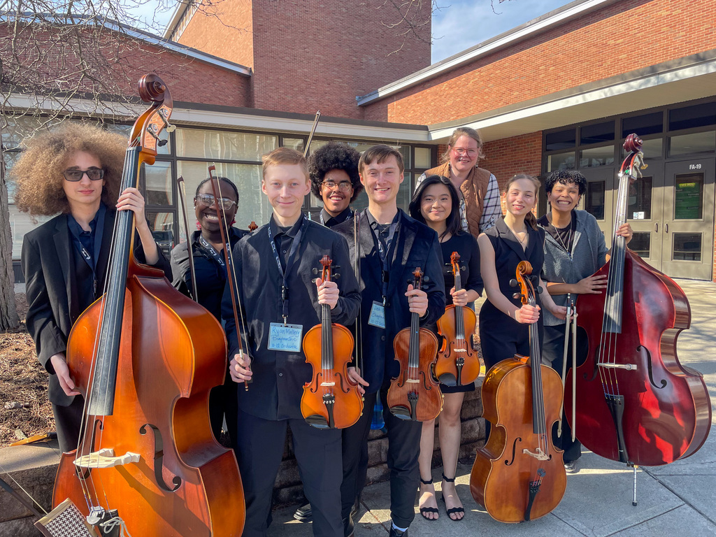 high school students pose for photo with string instruments