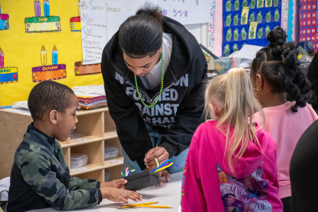 bhs visions fcu intern looks at elementary student's finished leprechaun trap