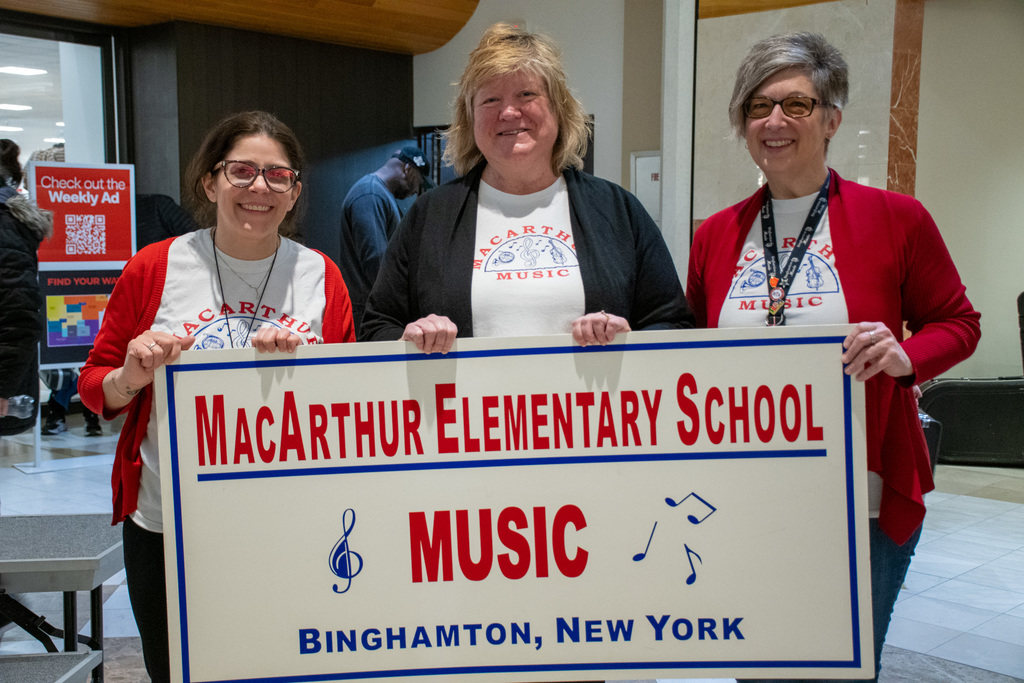 macarthur music directors pose for photo with macarthur music sign