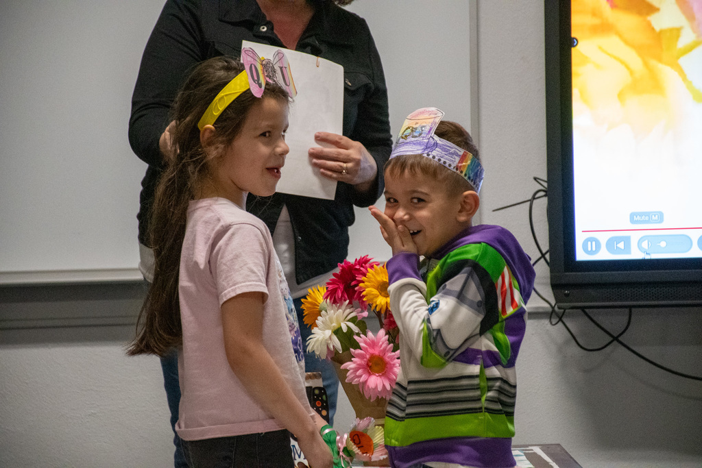 students acting out the wedding of the letters Q & U