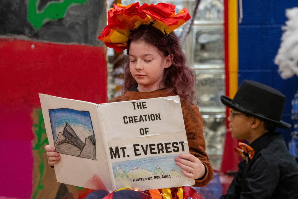 horace mann fifth grade student reads a book during odyssey of the mind skit
