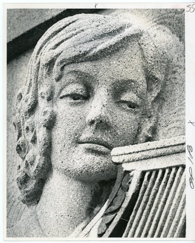 1931 photo of the face of a woman carved into the entrance of west middle school