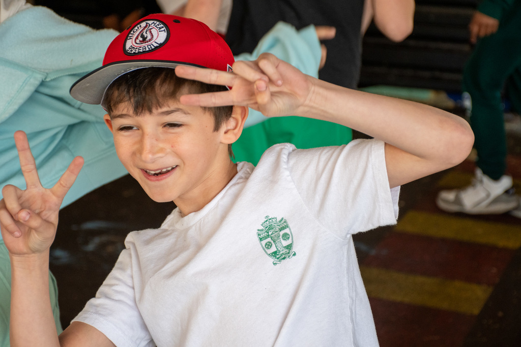 student gives double peace signs