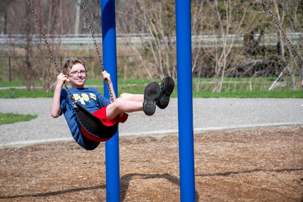 student swings on swing