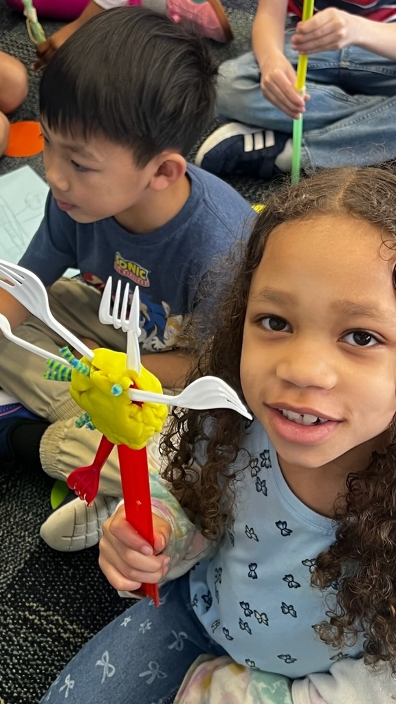 student shows off homemade back scratcher