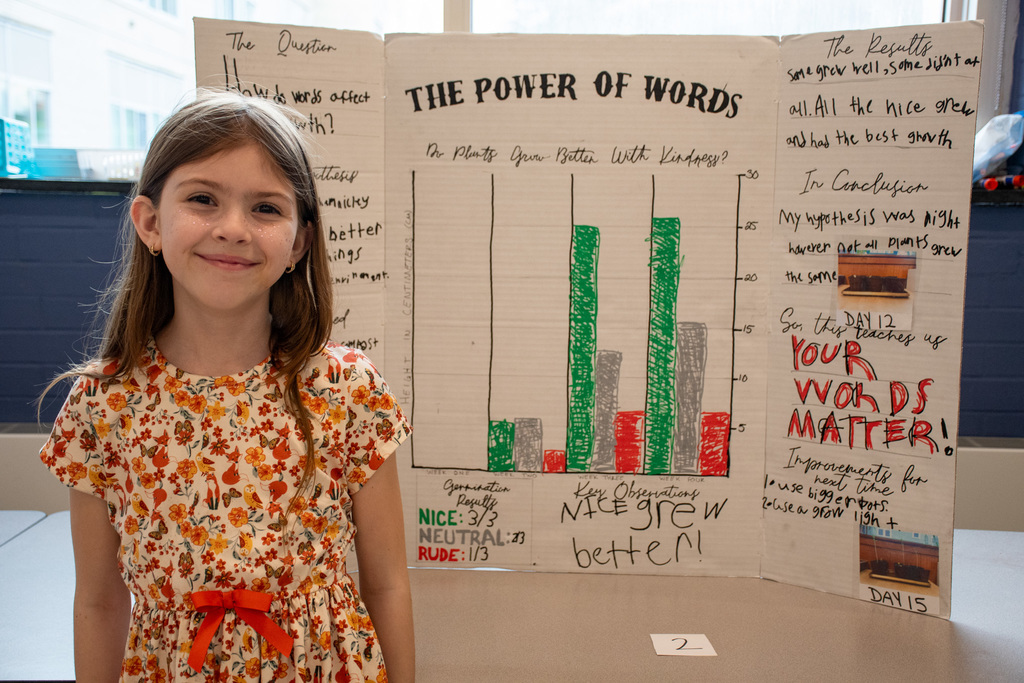 student poses with her science project