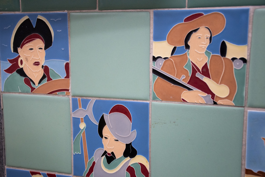 decorative tiles depicting a pirate, cowboy, and spanish explorer