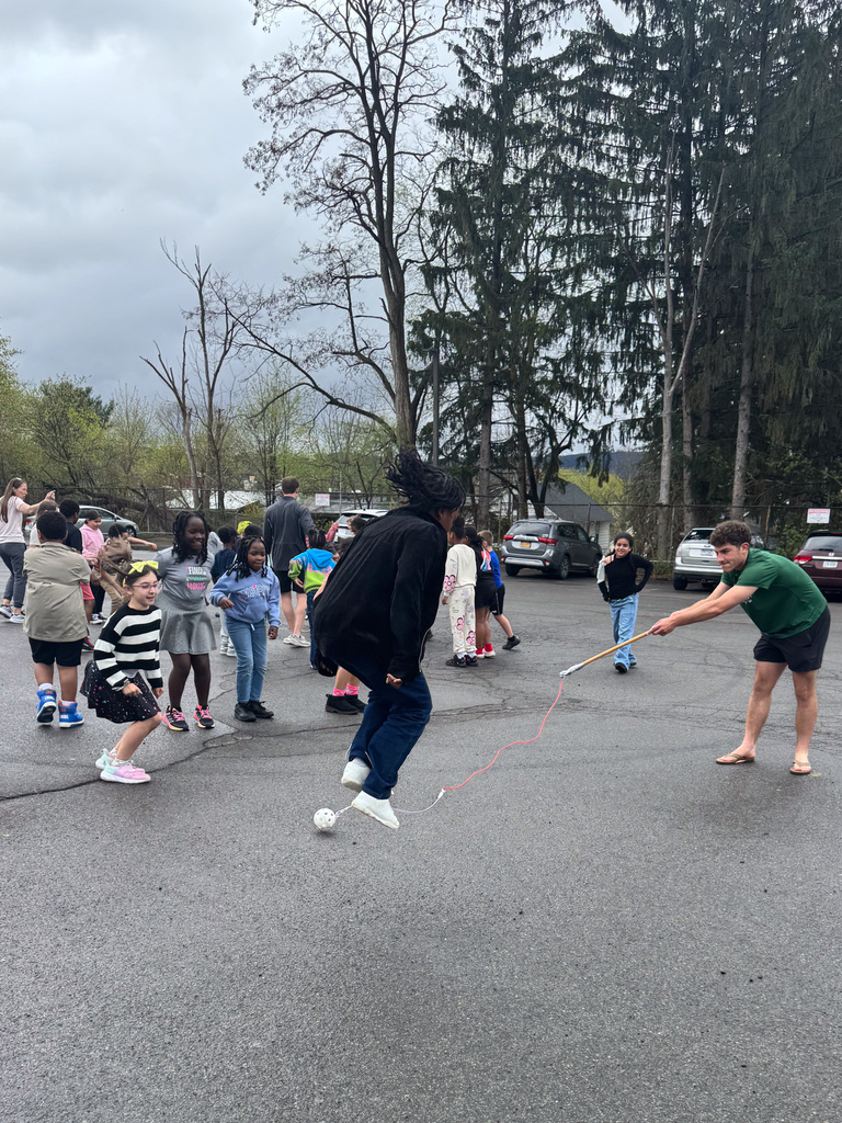 binghamton university men's soccer player plays with wilson students during recess