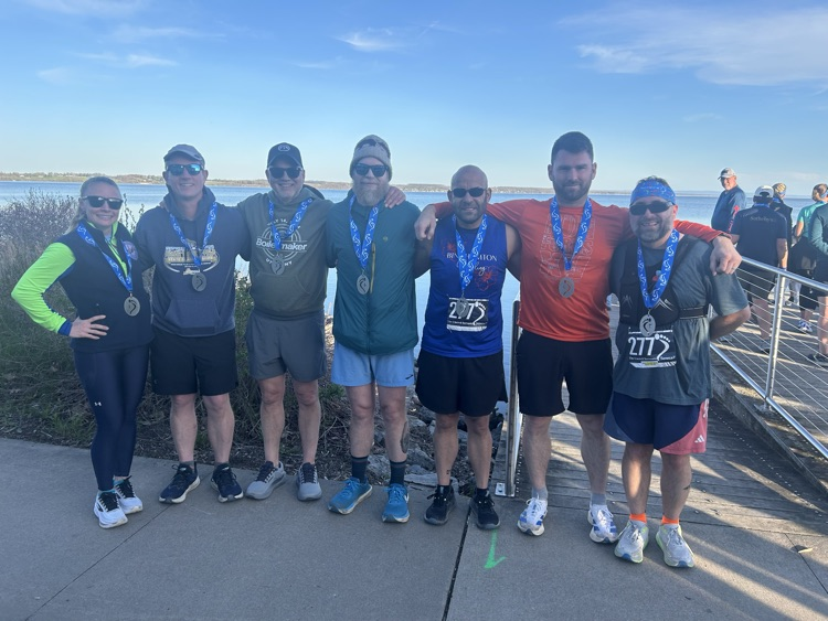 photo of 7 people wearing medals after race