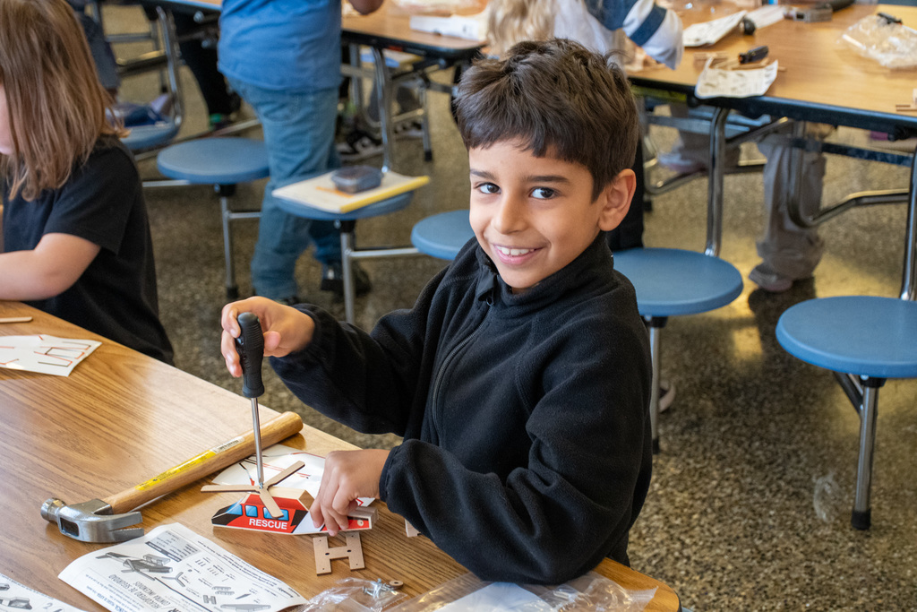 student uses screw driver