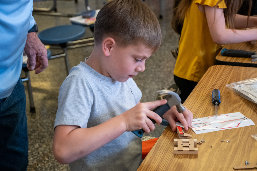 student uses hammer