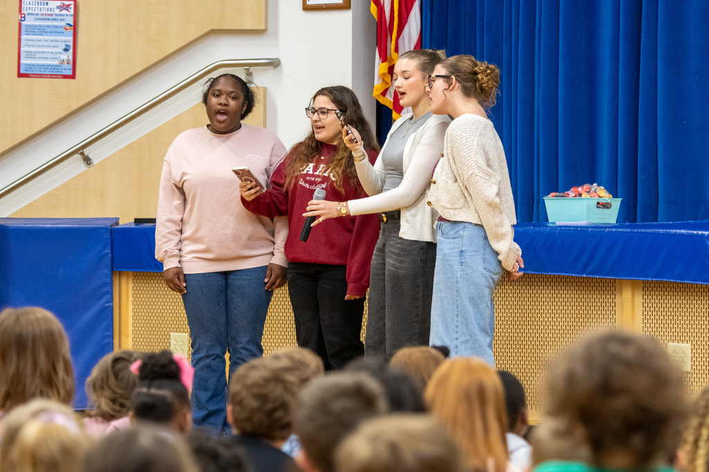 four students singing