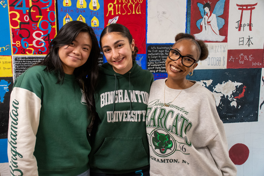 three students wearing binghamton university shirts