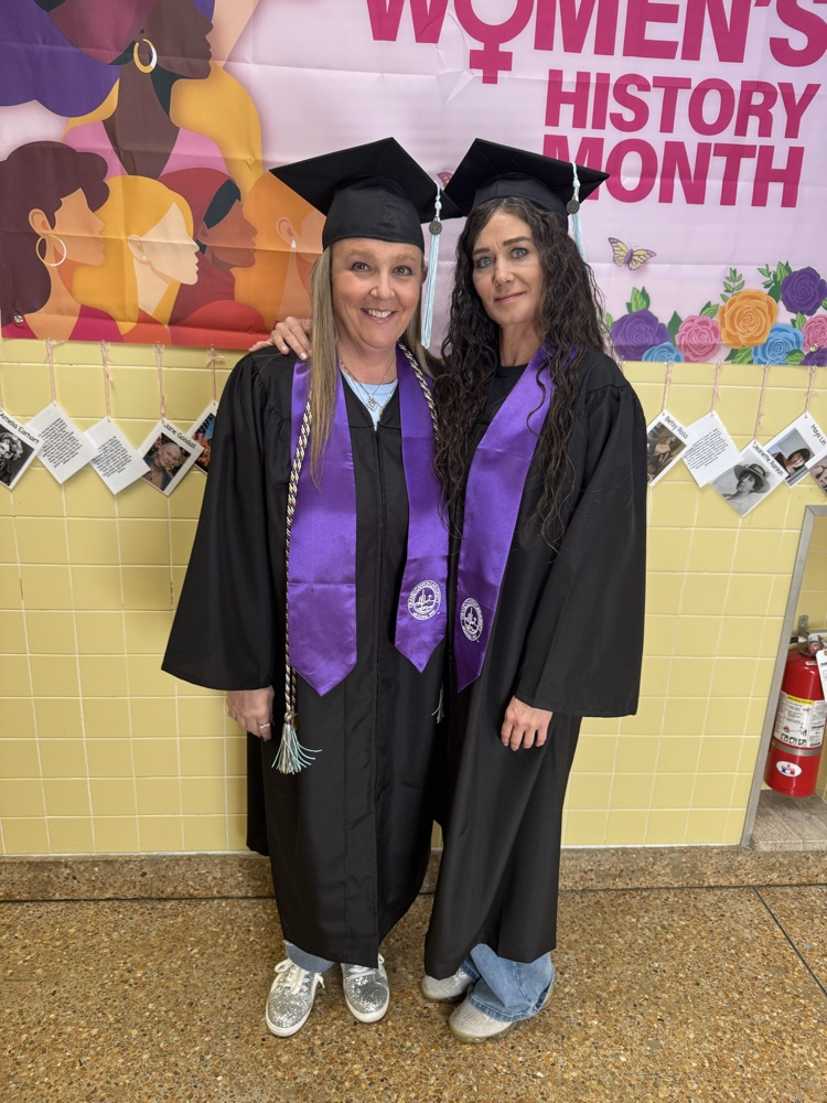 Wendy Walsh-Stettinius & Brandi Snyder posing for photo in graduation cap and gown