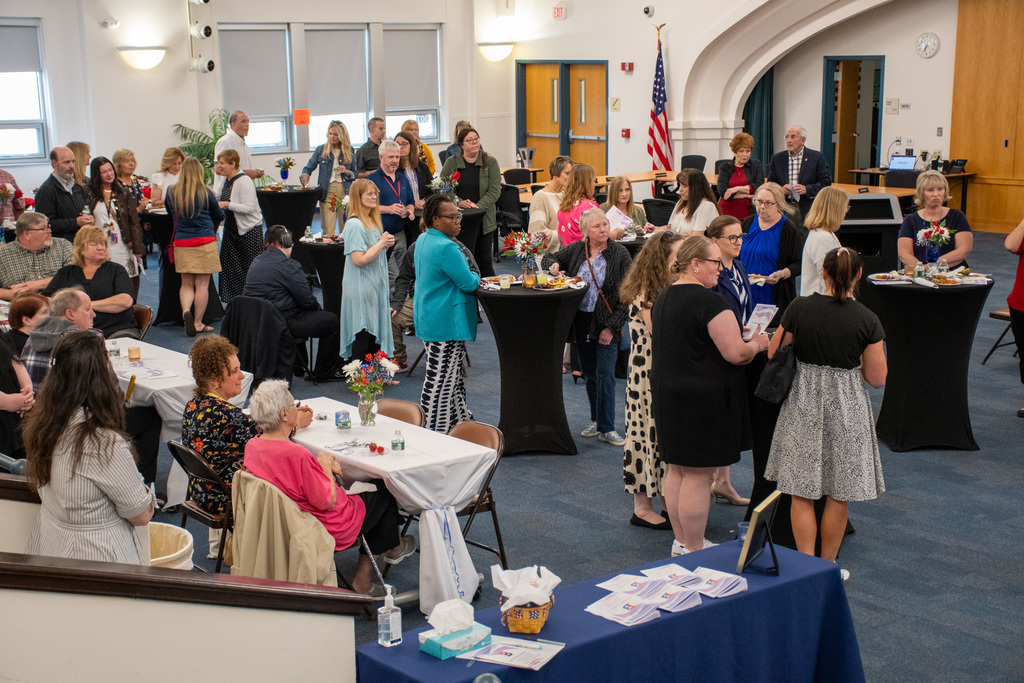 staff members chat and eat at the annual employee recognition event