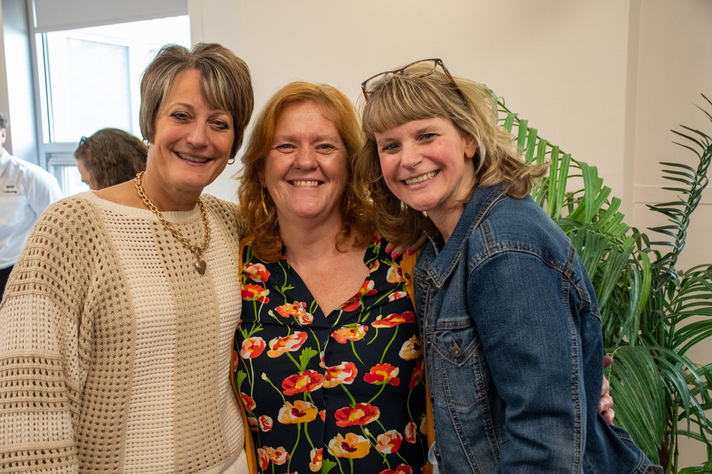 three staff members from theodore roosevelt pose for photo