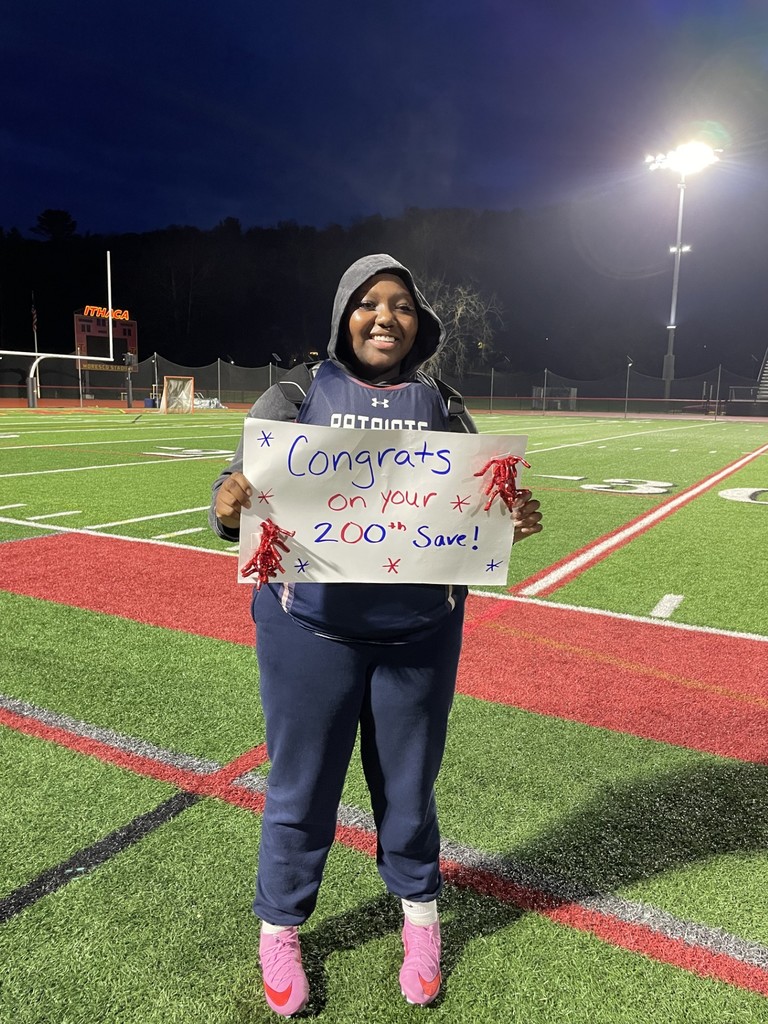 Patriots Girls Lacrosse goalie Nakiyah Bryant holds sign congratulating her on her 200th career save