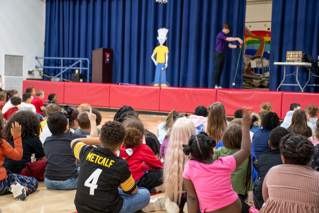 coolidge students watch presenter do yo-yo tricks on stage