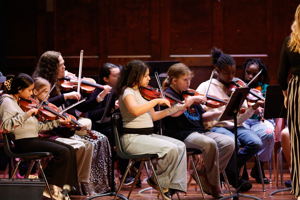 students play violins on stage at franklin spring concert